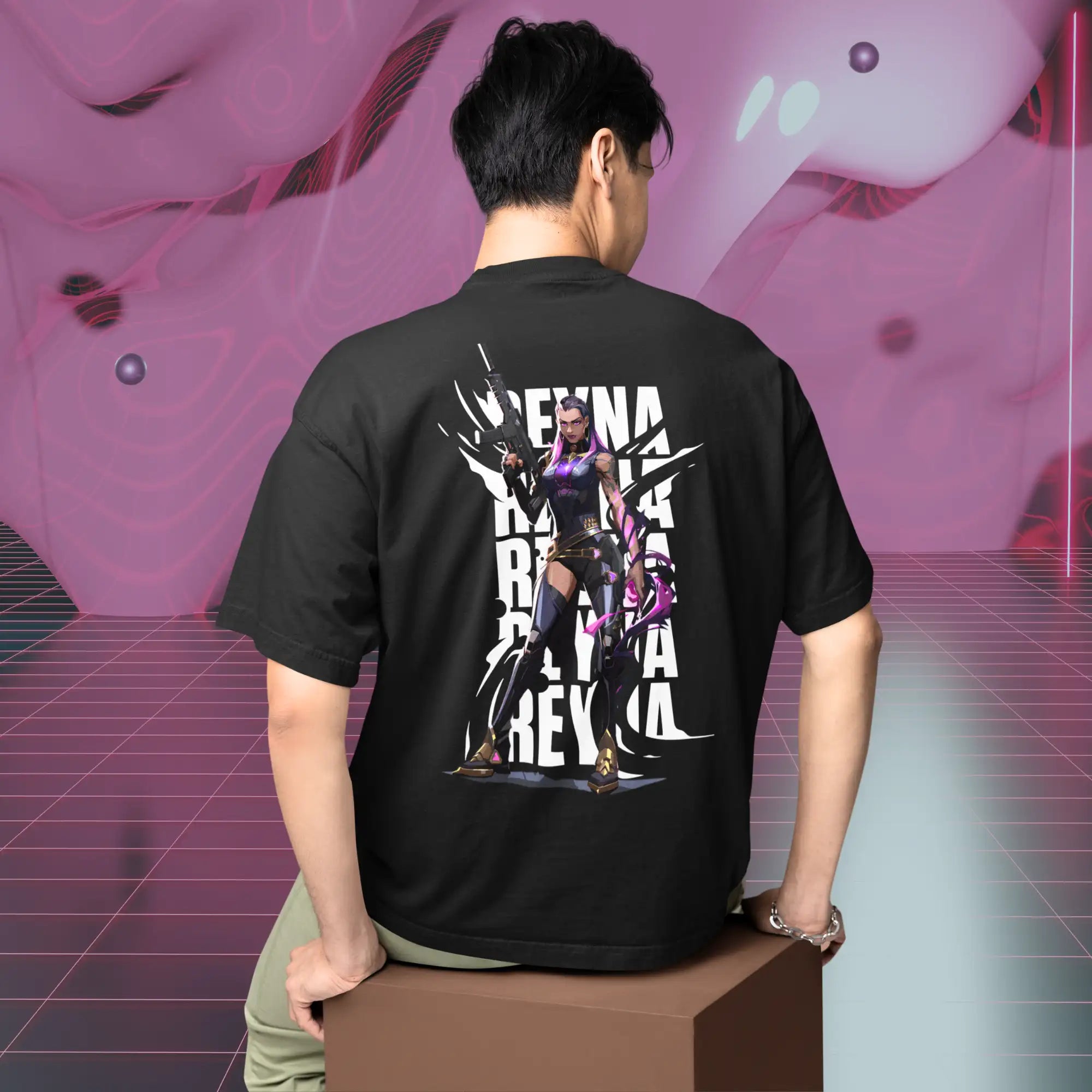 Black short-sleeved t-shirt featuring a bold graphic of the character reyna in purple and black armor with white text repeating her name.