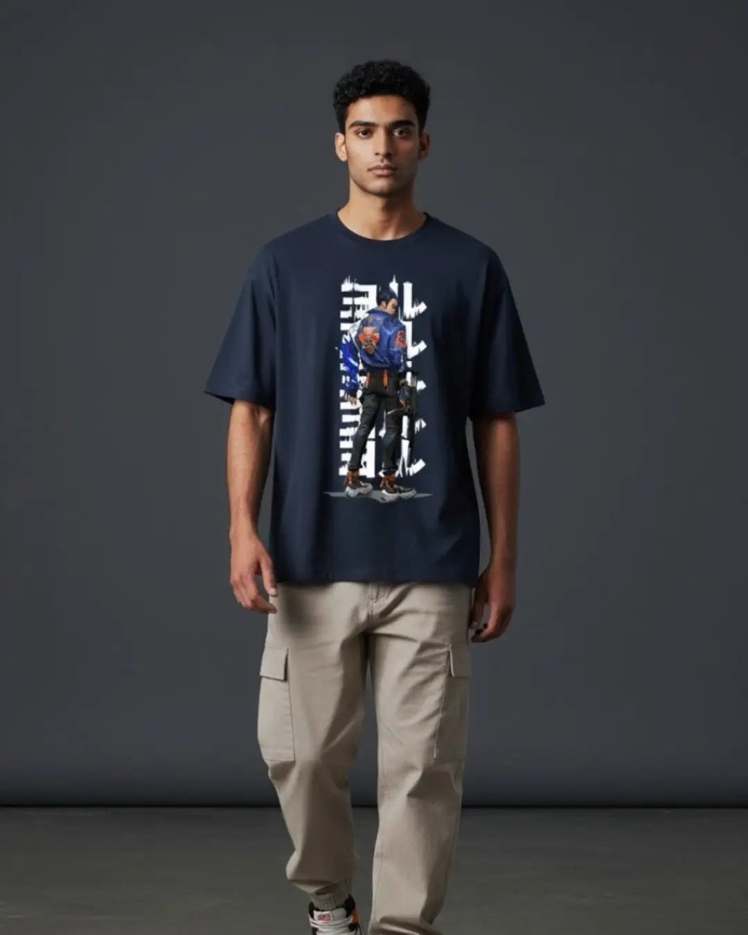 Man wearing a navy blue t-shirt with a graphic design against a dark gray background
